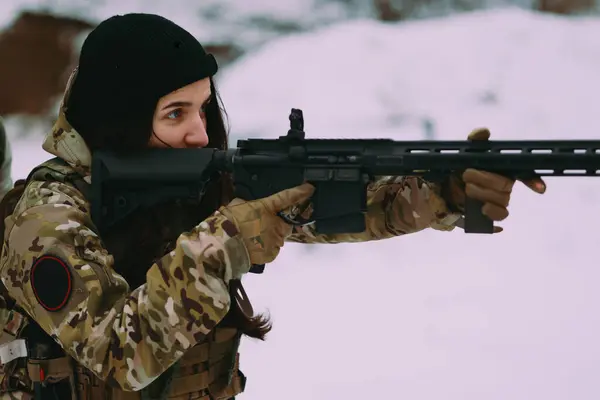 Military training. Woman training in tactical shooting.
