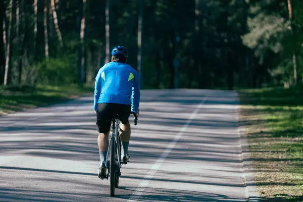 Male Cyclist Rides Road Forest Summer Day Royalty Free Stock Images