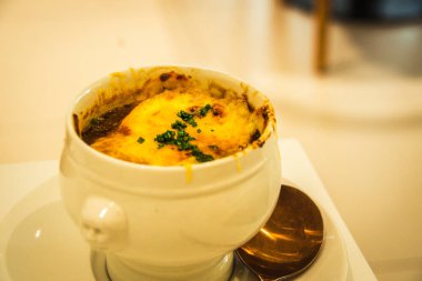 Geleneksel Fransız Soğan Öğütücü Çorbası beyaz bir porselen kasede