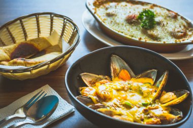 Kavanozda körili midye ve pide ile servis edilir.