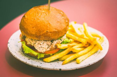 Hafif mayonezli buğulanmış kar yengeci, üstüne guacamole sosu, kızarmış soğan, kıvırcık salata ve domatesli çörek.