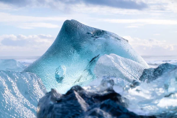 アイスランドのダイヤモンドビーチ 明確な氷を持つ氷山の一片 日没時の氷の中の反射と光 アイスランド旅行のための人気のある目的地 — ストック写真