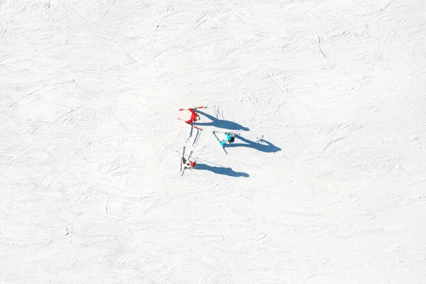 Ski resort. An aerial view of the ski team. Winter sports. Snow slope in the mountains for sports. Group training. Exercise with friends. winter landscape from a drone.