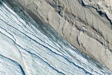 View of the moraines. Glacier and rocks. Landscape from the air.  River on a moraine. Landscape from drone. Alberta, Canada. clipart