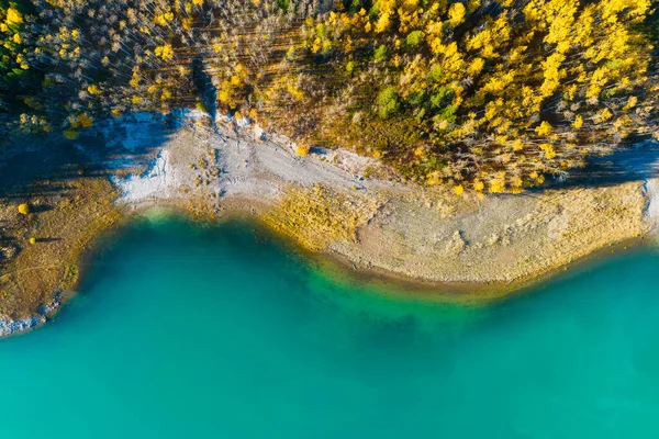 Drone view of the lake and forest in the glacier valley. View of the moraines. Landscape from the air.  Lake on a moraine. Landscape from drone. Abstract view for wallpaper. Alberta, Canada.
