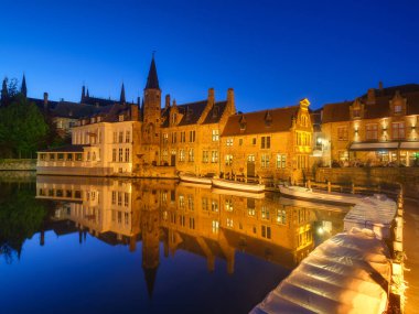Bruges, Belçika. Şehrin tarihsel bir parçası. Mavi saat boyunca mimari bir manzara. Eski ünlü binalar. Suyun yüzeyindeki yansımalar. Duvar kağıdı, kartpostallar, arkaplan, tasarım için resim.