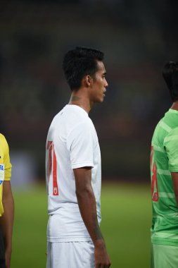 PATHUMTHANI, THAILAND -11 DECEMBER, 2022: Mg Mg Lwin #11 Player of myanmar during friendly match between thailand against myanmar at thammasart stadium , thailand clipart