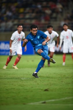 Pathumthani, Thailand - December 11, 2022: Teerasil Dangda #10 player of Thailand during friendly match between Thailand against Myanmar at Thammasat stadium in Thailand. clipart