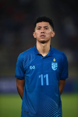 Pathumthani, Thailand - December 11, 2022: Bordin Phala #11 Player of Thailand during friendly match between Thailand against Myanmar at Thammasat stadium in Thailand. clipart