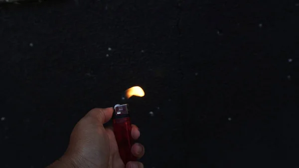 Left Hand Holding Lighter Holding Yellow Lighter Burning Flame Black — Stock Photo, Image