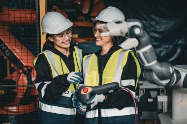 Engineer training with new robotics machine in Factory