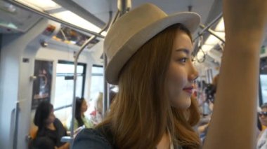 Genç Asyalı kadın turist Tayland 'da gökyüzü treniyle Bangkok' a seyahat ediyor..