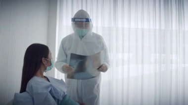 Asyalı erkek doktor hastanedeki Asyalı kadın hastanın röntgen testini yapıyor.