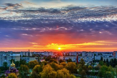 Şehir binalarının üzerinde gün doğumu. Yükseklikten görüntüle.