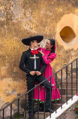 young hispanic woman and man in independence day or cinco de mayo parade or cultural Festival clipart