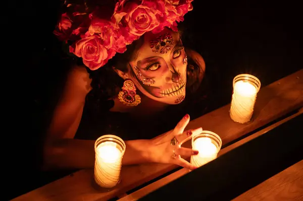 Calavera Catrina sitting on a throne. Sugar skull makeup. Dia de los muertos. Day of The Dead. Halloween.