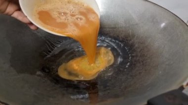 Omelets fried in hot coconut oil