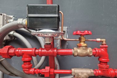 Pressure gauge for measuring installed in water system on technology background