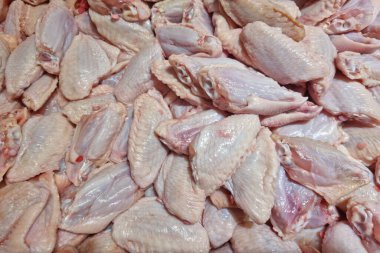Fresh chicken meat turned into pieces on food background