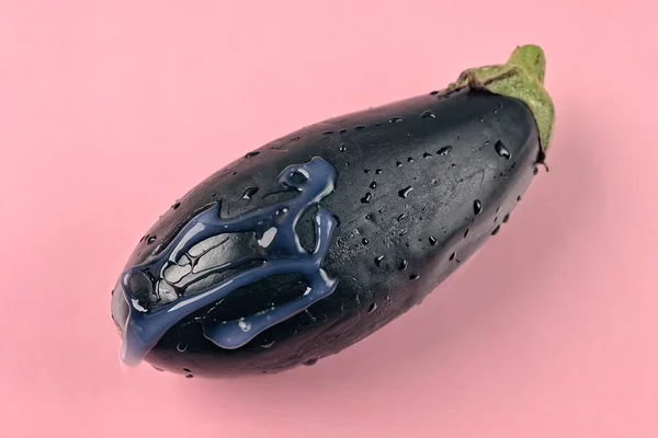 Eggplant isolated on pink background. Reproductive health and safety education concept