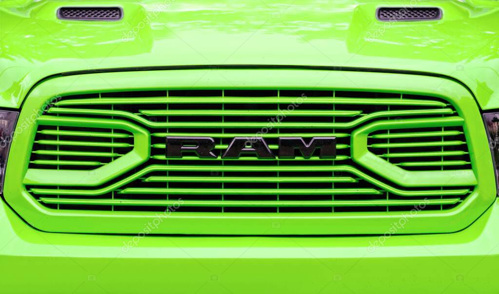 Senden, Germany - June, 04, 2025: Closeup of a RAM logo on the grille of a green truck. Panoramic image.