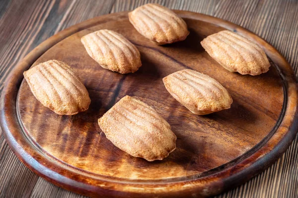 stock image Madeleines - French small sponge cakes on the serving board