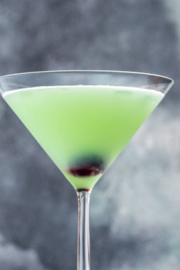 Japanese Slipper Cocktail in martini glass garnished with cherry