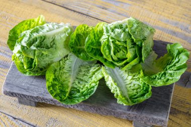 Two heads of Romaine lettuce on the cutting board