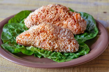 Portion of Sesame Crusted Salmon on lettuce