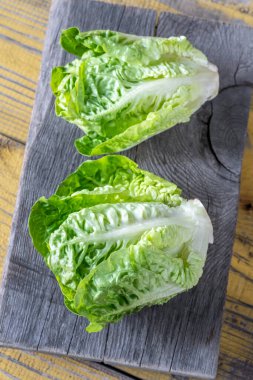 Two heads of Romaine lettuce on the cutting board