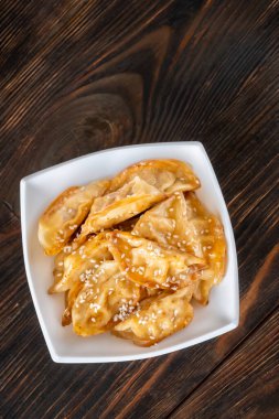 Portion of pan fried gyoza dumplings in the bowl
