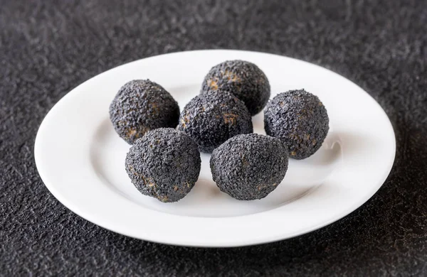 stock image Mozzarella balls breaded with black truffle on the plate