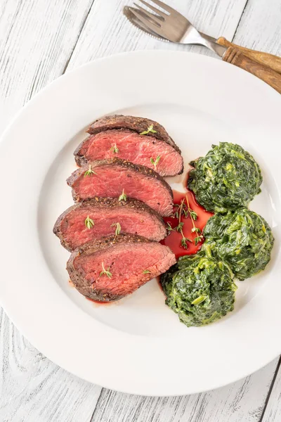 stock image Flank steak with creamy spinach on the plate