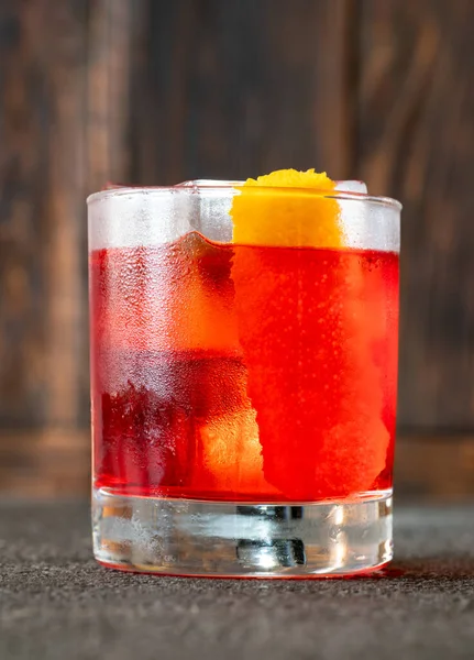 stock image Glass of Negroni cocktail garnished with orange peel