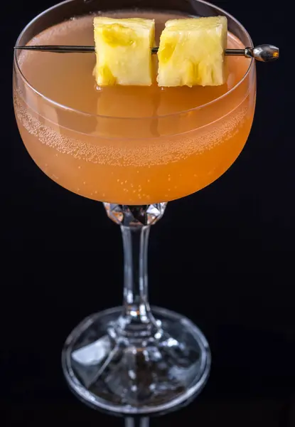 Only fans Martini cocktail garnished with pineapple cubes