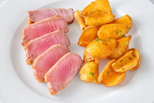 Portion Thunfisch Mit Kartoffeldipperl Auf Dem Teller Stockfoto