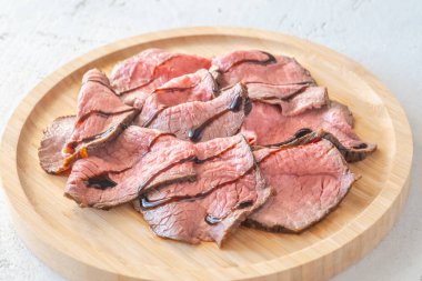 Portion of sliced roast beef on the plate clipart