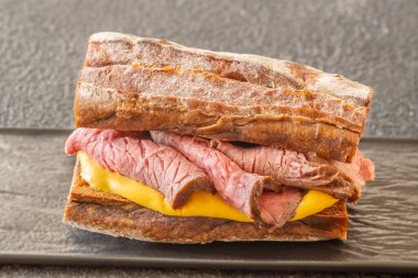 Sandwich with sliced roast beef and cheese clipart