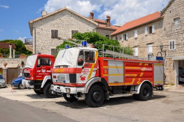Perast, Montenegro - June 6, 2022: Historic fire car on waterfront town of Perast. Kotor Bay in Montenegro