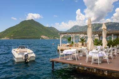Perast, Montenegro - June 6, 2022: Seaside restaurant cafe in the picturesque town of Perast in Montenegro