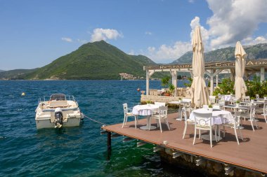 Perast, Montenegro - June 6, 2022: Seaside restaurant cafe in the picturesque town of Perast in Montenegro