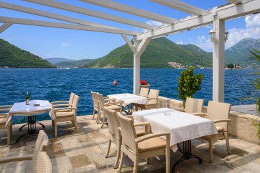 Perast, Montenegro - June 6, 2022: Seaside restaurant cafe in the picturesque town of Perast in Montenegro