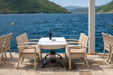 Typical seaside restaurant overlooking the beautiful Bay of Kotor in Montenegro. Europe