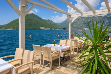 Perast, Montenegro - June 6, 2022: Seaside restaurant cafe in the picturesque town of Perast in Montenegro