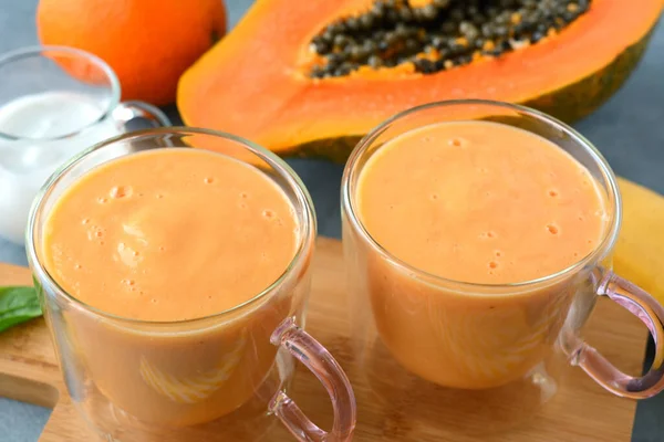 stock image Fresh papaya, banana, orange fruit smoothie with coconut milk