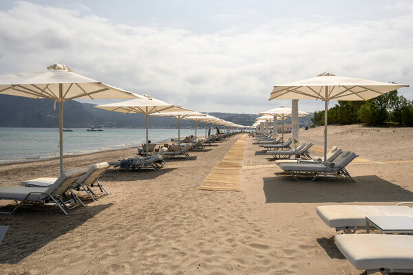 Kos, Greece - May 12, 2024: Agios Stefanos beach, a long beach of sand and fine pebbles on the island of Kos. Greece