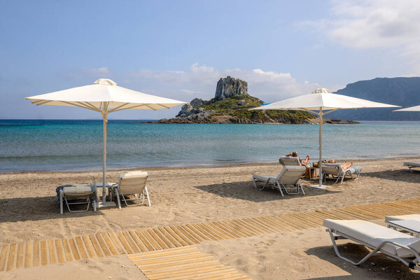 Kos, Greece - May 12, 2024: Agios Stefanos beach, a long beach of sand and fine pebbles on the island of Kos. Greece