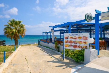 Kos, Greece - May 12, 2023: Greek seaside restaurant next to the Kefalos beach. Kos, Greece clipart