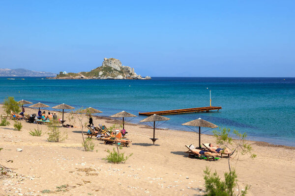 Kos, Greece - May 12, 2023: Tourists sunbathing Kefalos beach on the island of Kos. Greece