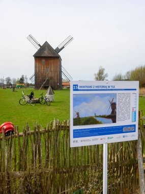 Mokry Dwor, Poland - April 7, 2024: Traditional wooden paltrak windmill in Mokry Dwor village. Educational Farm in Zulawy. Poland clipart